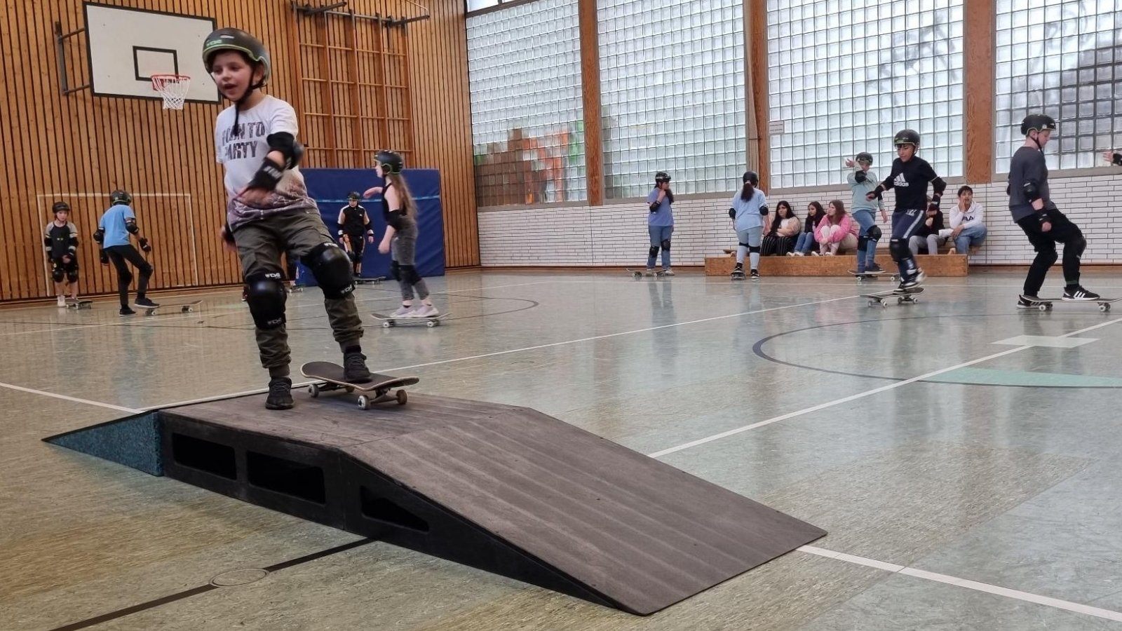 Kind fährt mit Skateboard über Rampe