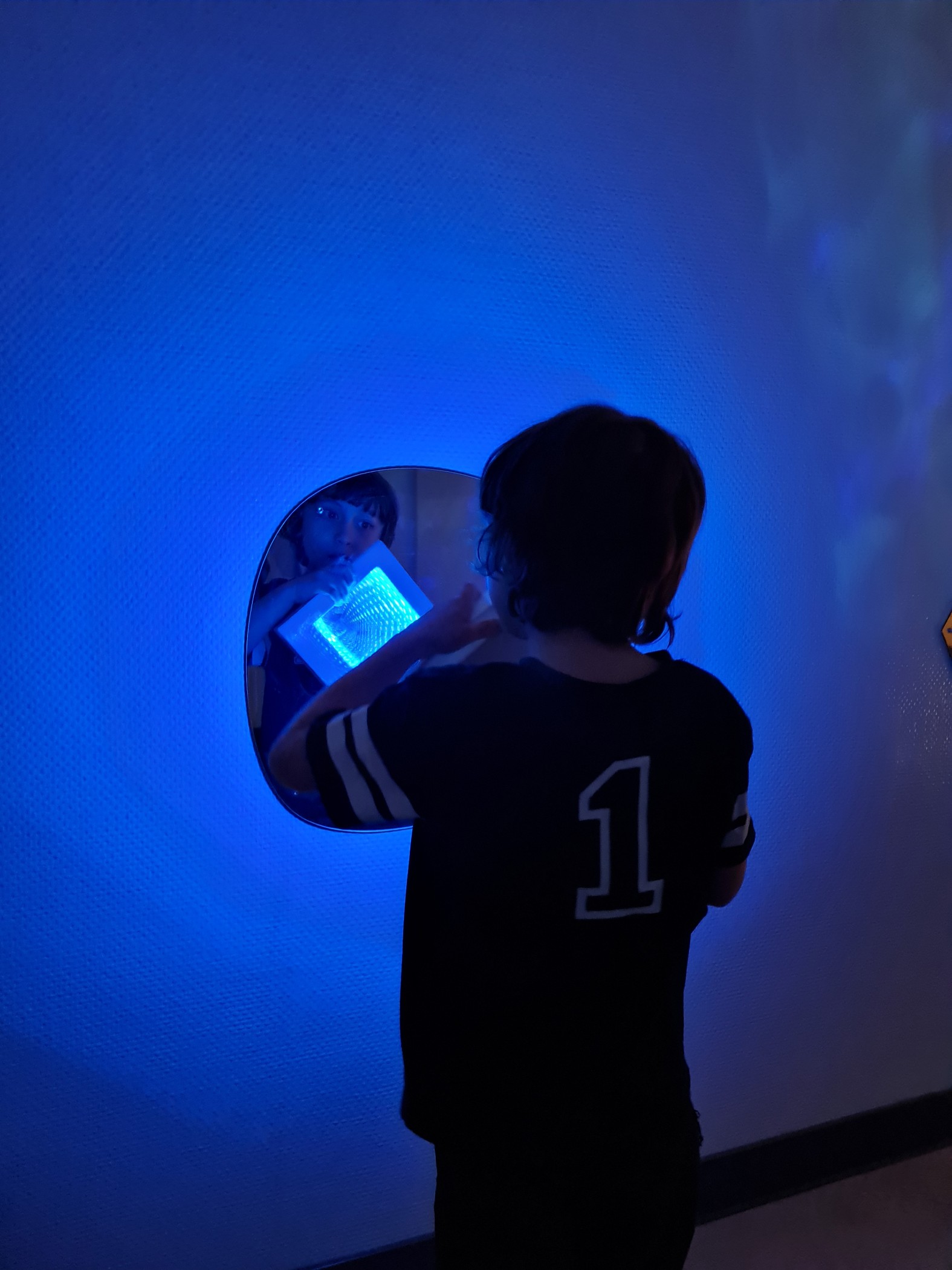 Junge vor Spiegel mit Licht